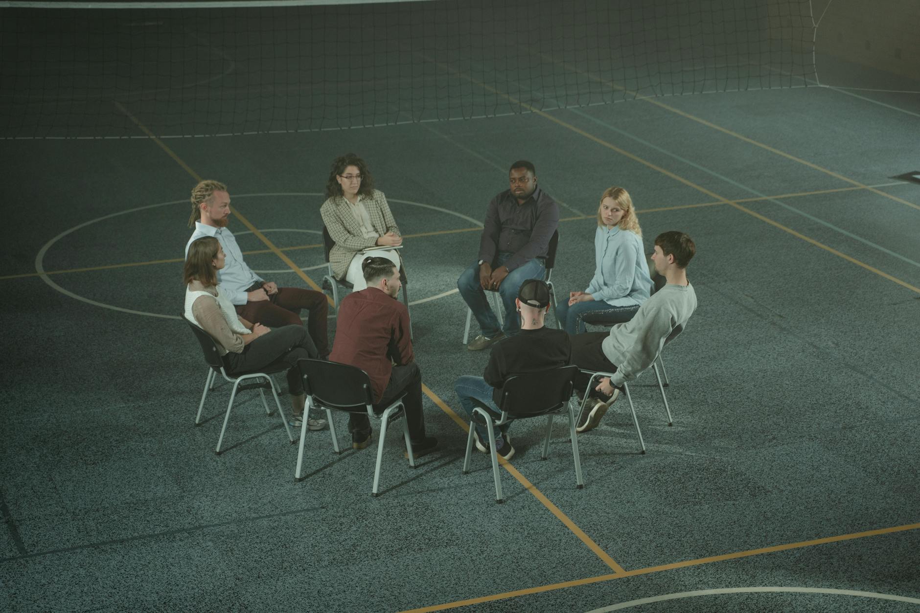 group of people sitting on white chairs